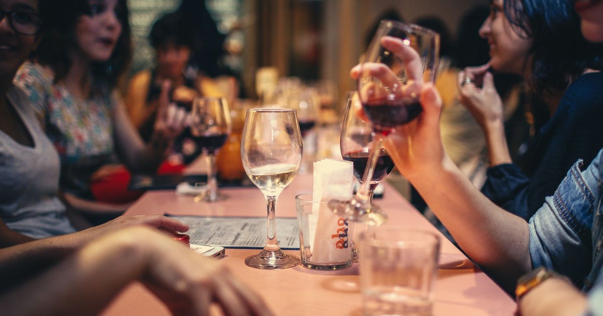 Friends enjoying dinner together at a local restaurant table