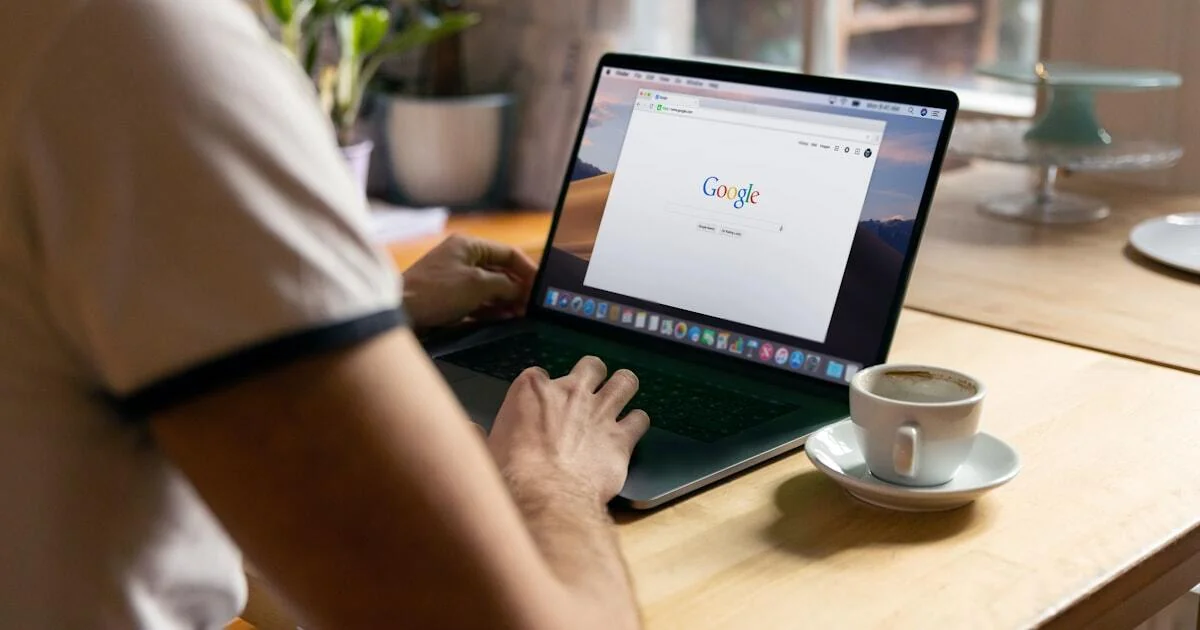 Person searching on Google from laptop